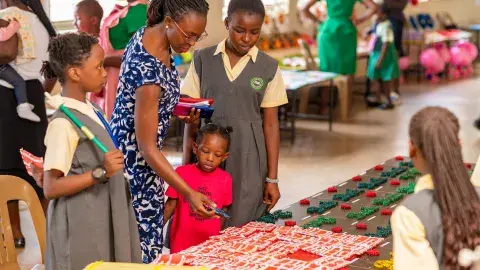 Maama Karen listening to display